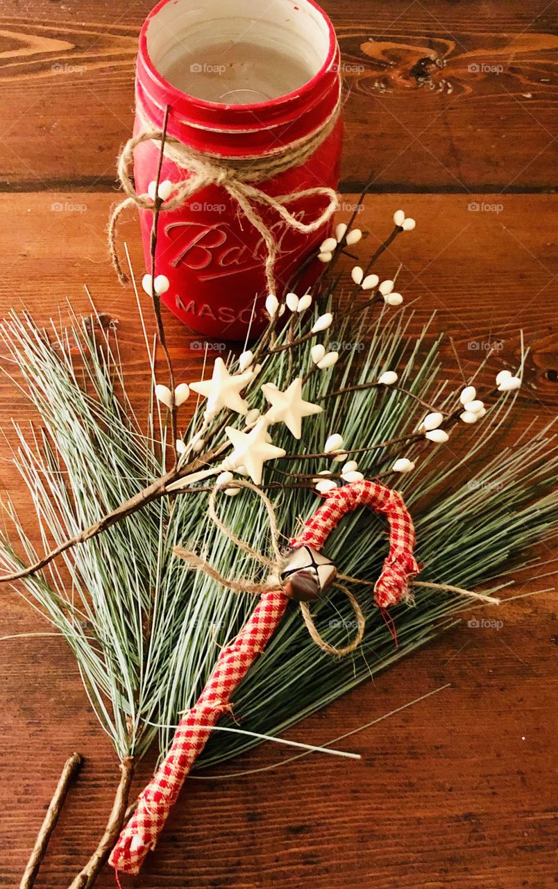 Christmas crafting flat lay mason jar pip berries, Homespun candy cane on a wood table 