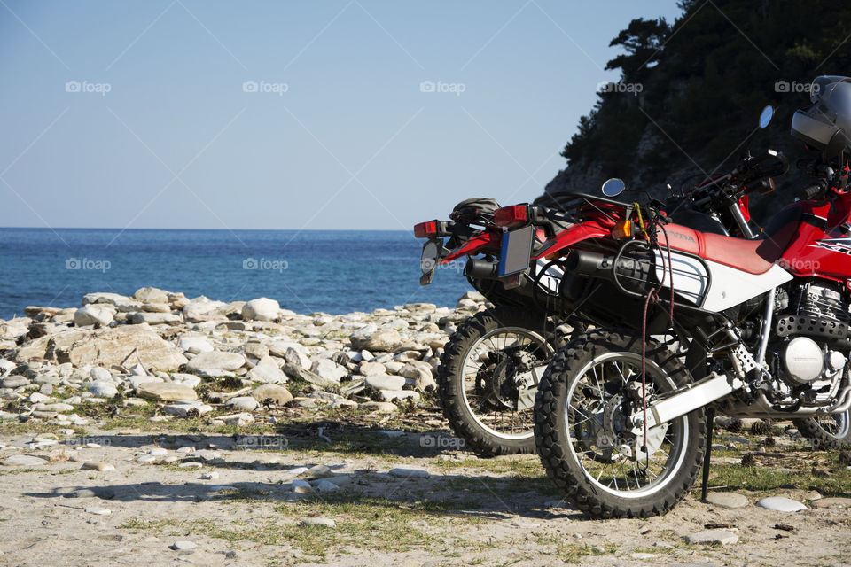 honda motorbikes on beach. honda sport motorbikes parked on livadi beach in southern part of Thassos island in Greece