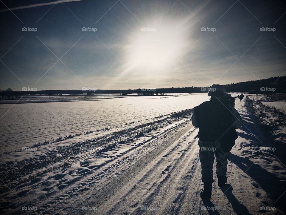 Soldiers hiking winter. Finnish soldiers hiking on a snowy field.