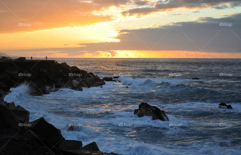 beautiful sunset over the atlantic ocean on tenerife canary island in spain - rock and waved