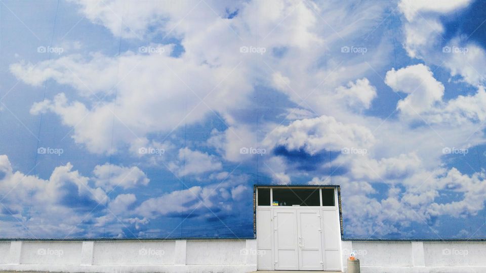 View of clouds on poster and door