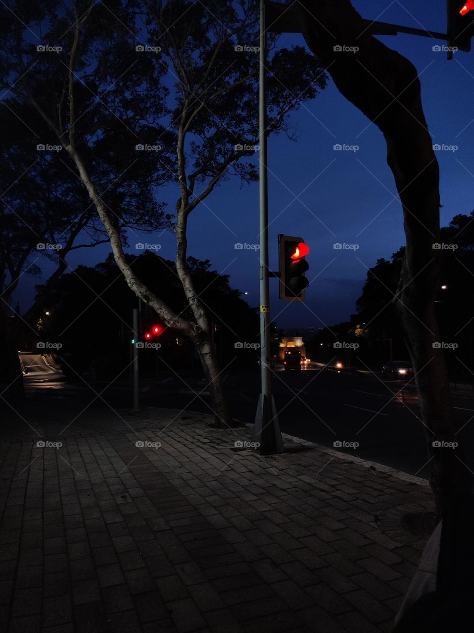Empty street in the night in Malta/ Late night time with lights on an empty street/ Dark sidewalk in the evening in the capital of Malta