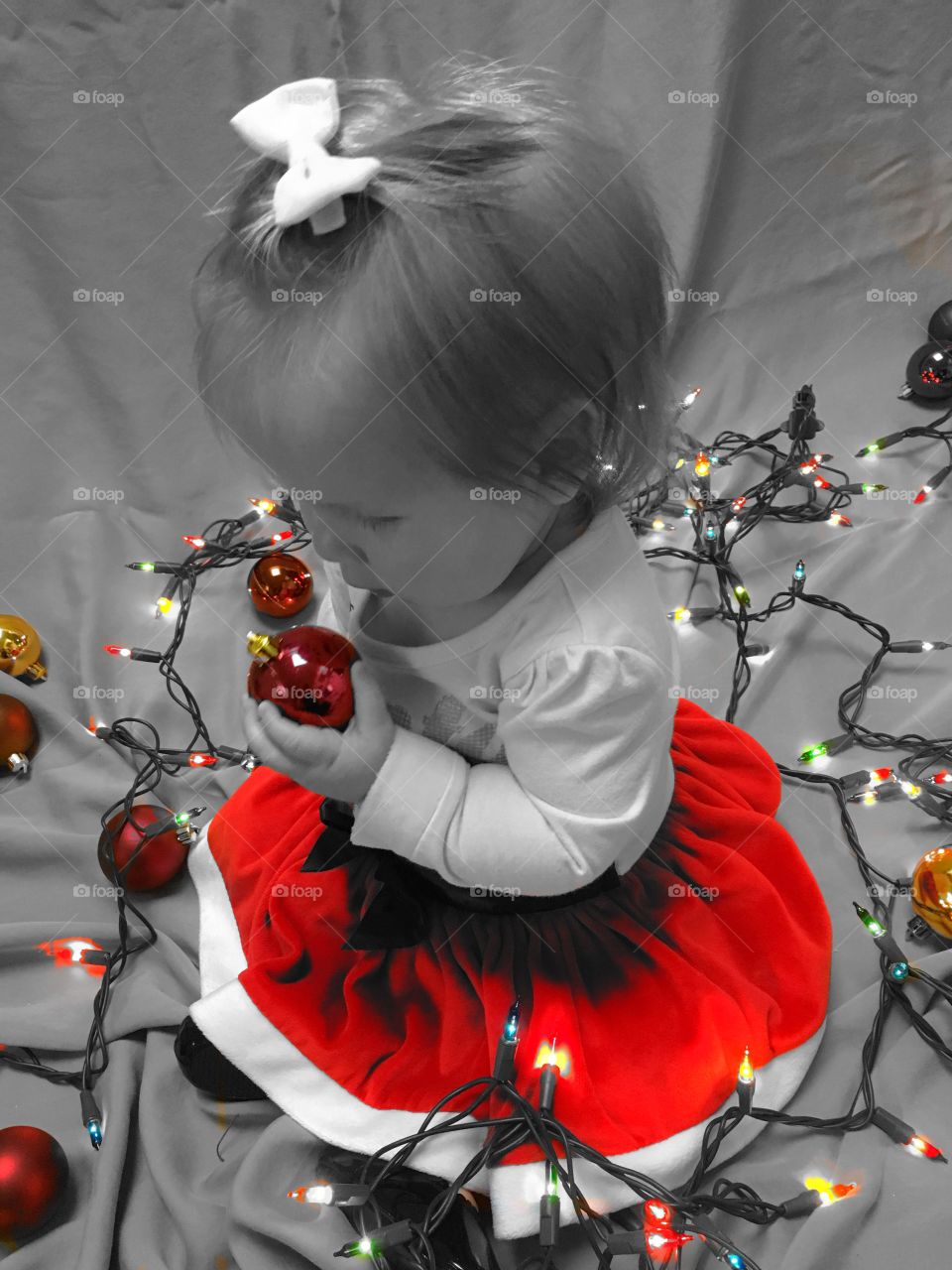 Baby holding Christmas ornament