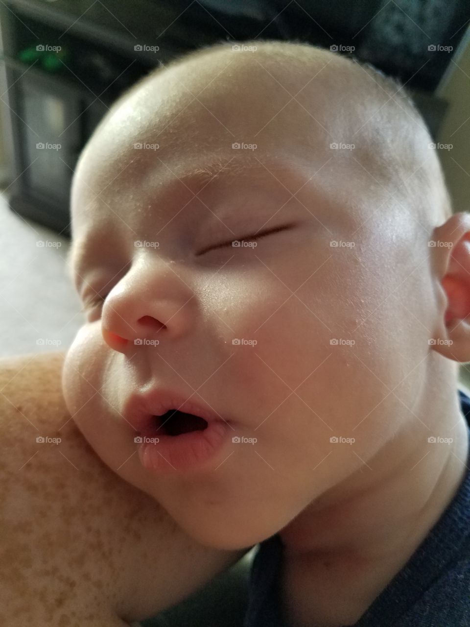 my son sleeping peacefully on my freckled arm