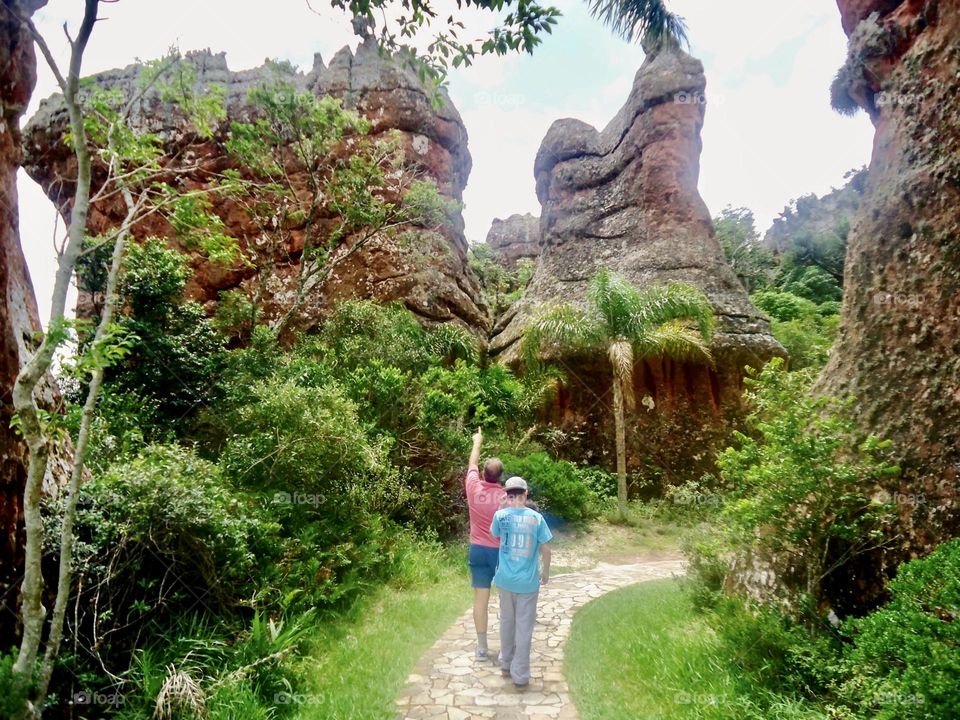 Father and son walking in the park in Vila Velha, Brazil