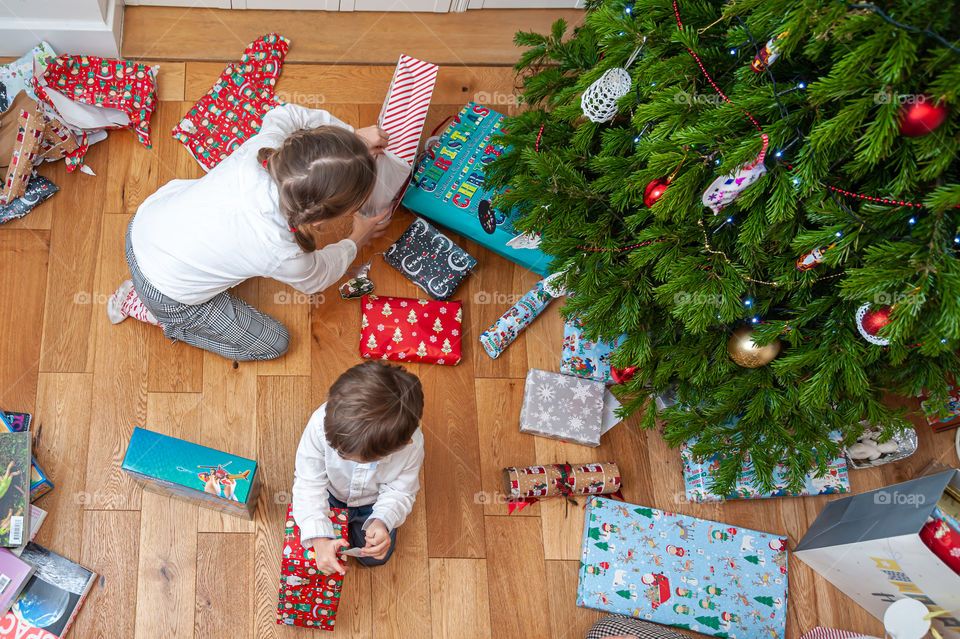 24 of December. Christmas Eve. Unwrapping Christmas presents by children.