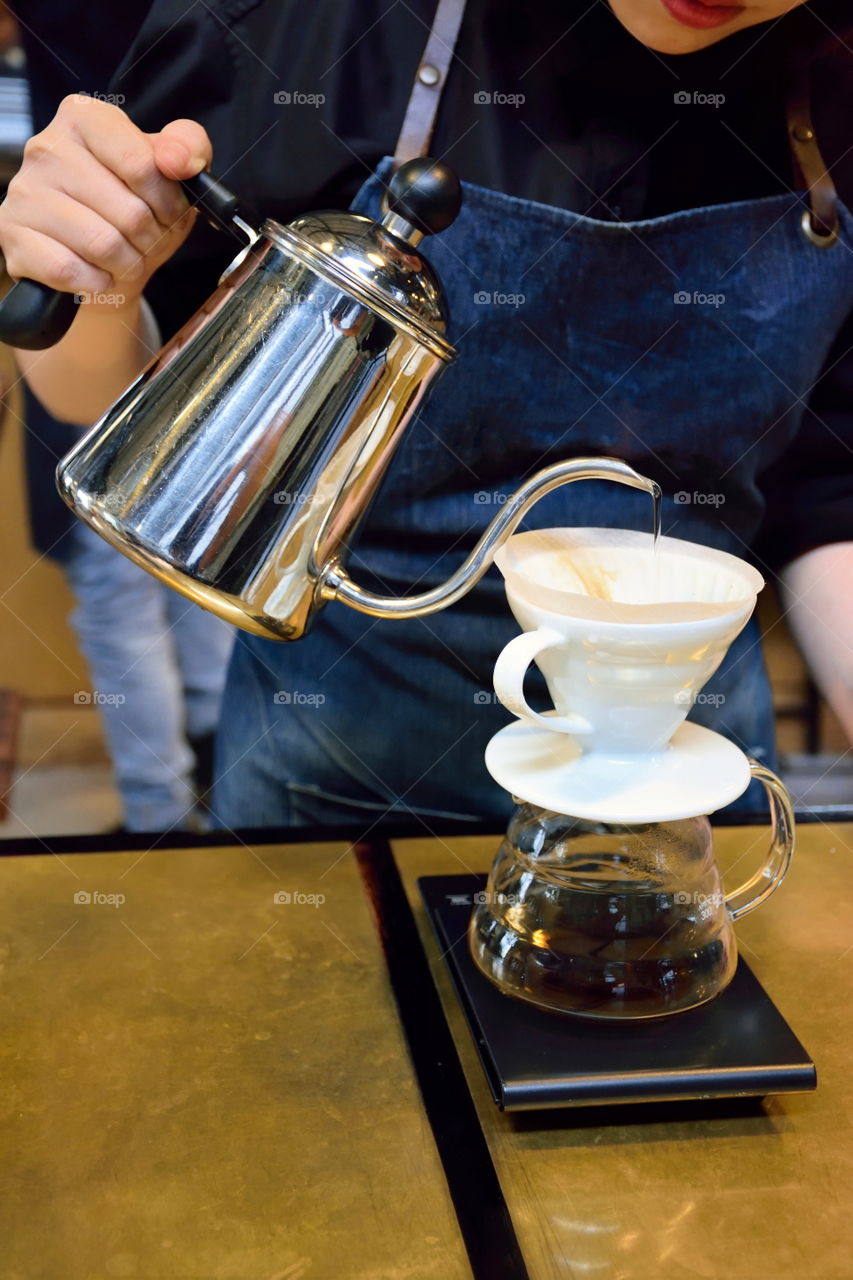 Barista dripping coffee