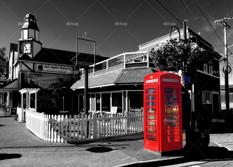 Red telephone box on sidewalk