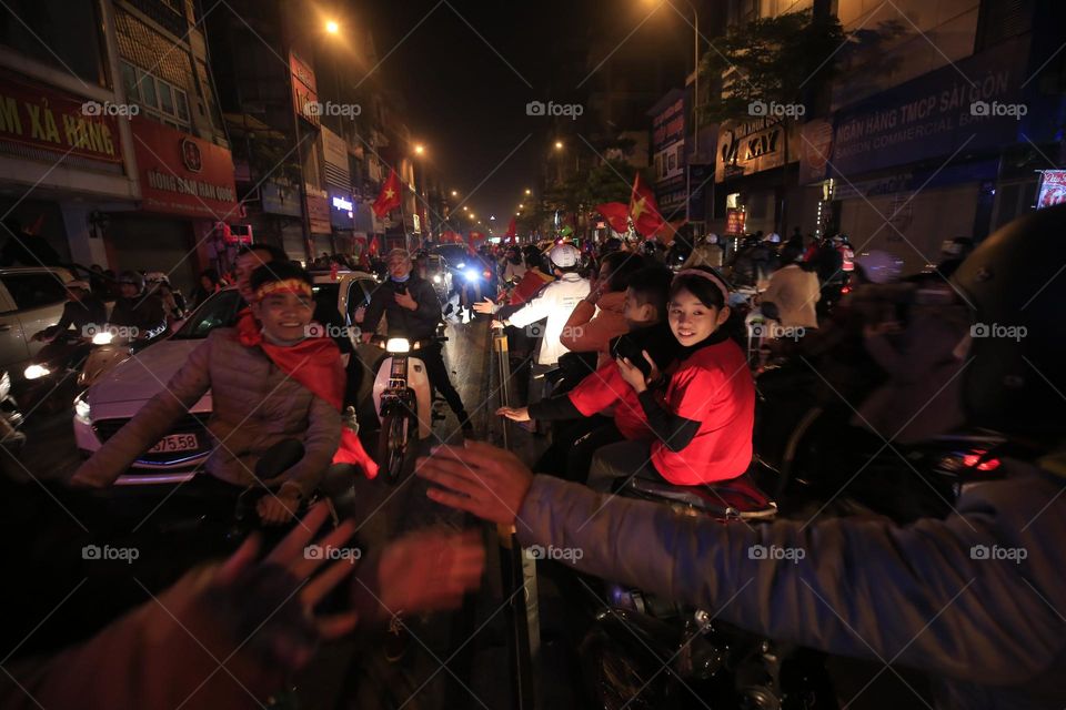 Vietnamese people parade to celebrate a win football matche