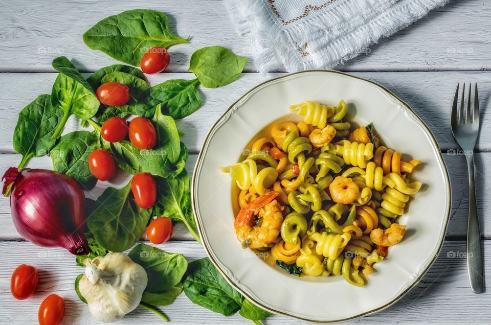 Coloured pasta and prawns