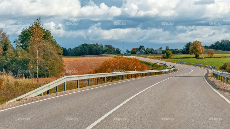 autumn landscape with asphalt road and forest