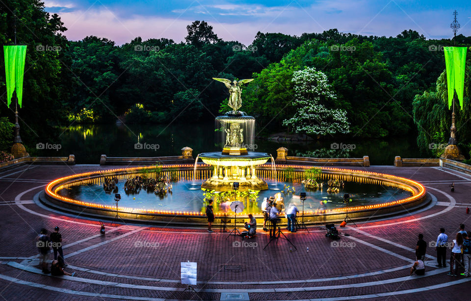 The Bethesda Fountain in Central Park covered with candles during sunset.