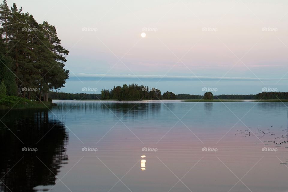 Full moon over the calm lake