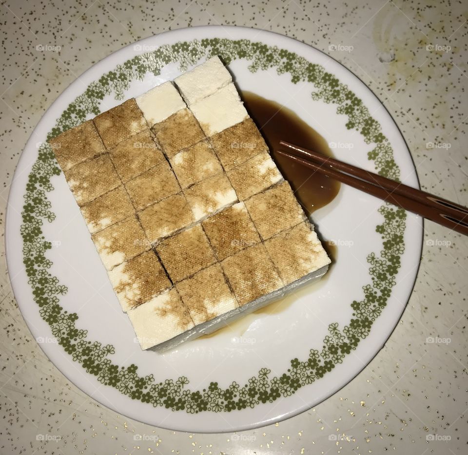 Tofu for dinner. It is is a healthy way to eat dinner. Soy sauce and olive oil are added to make the food healthier for consumption.