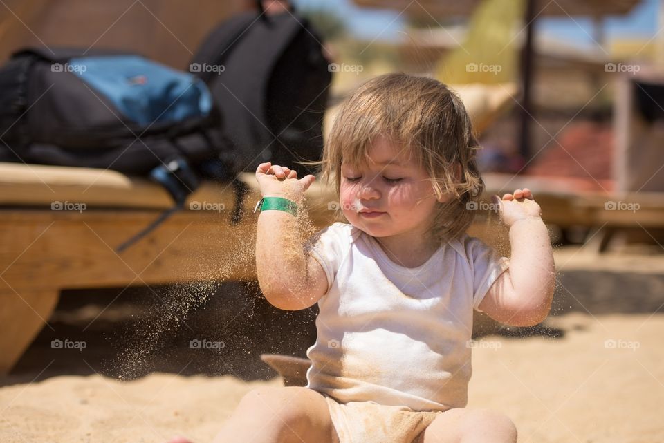baby girl playing in the sand