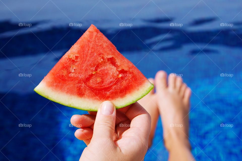 Eating watermelon by the pool 