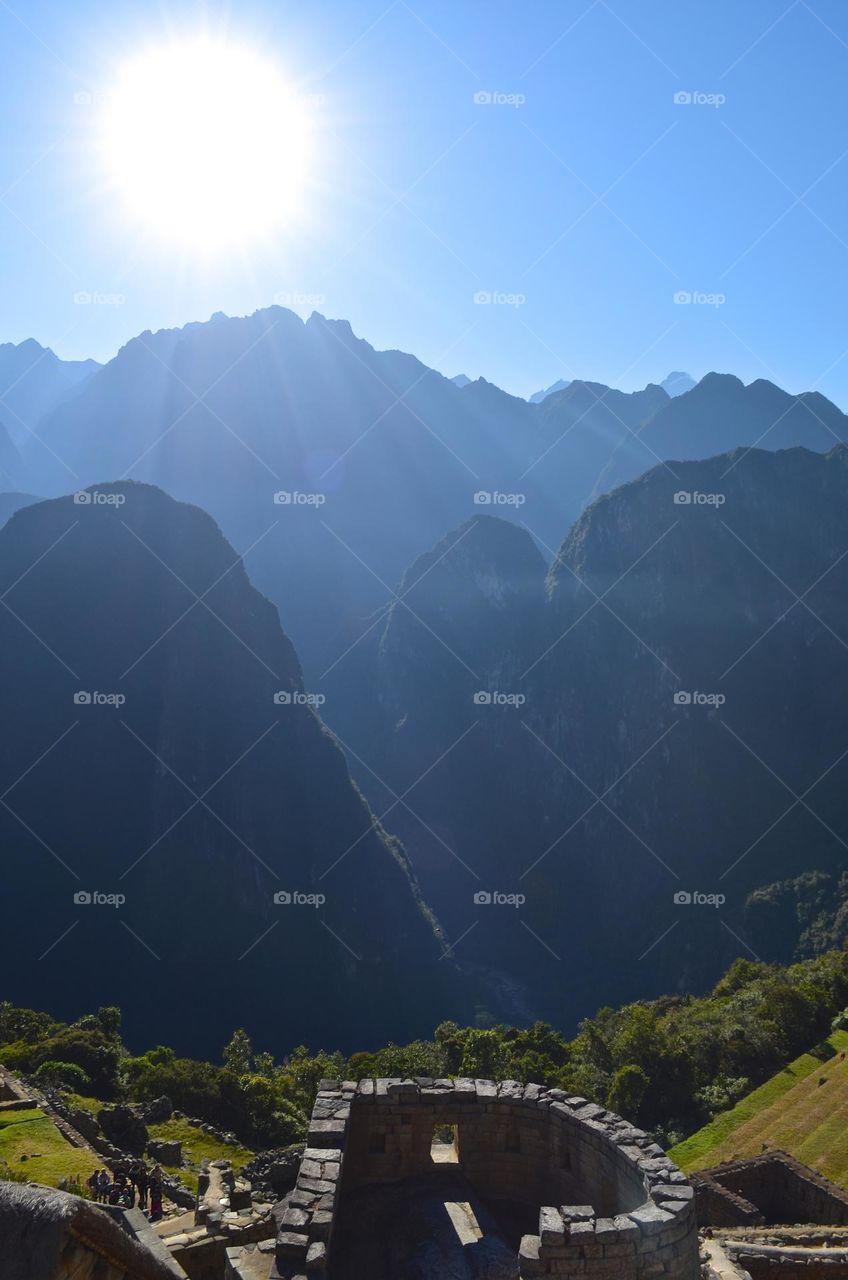 Morning sunshine and Sun temple views in Machu Picchu archaeological site, Peru.