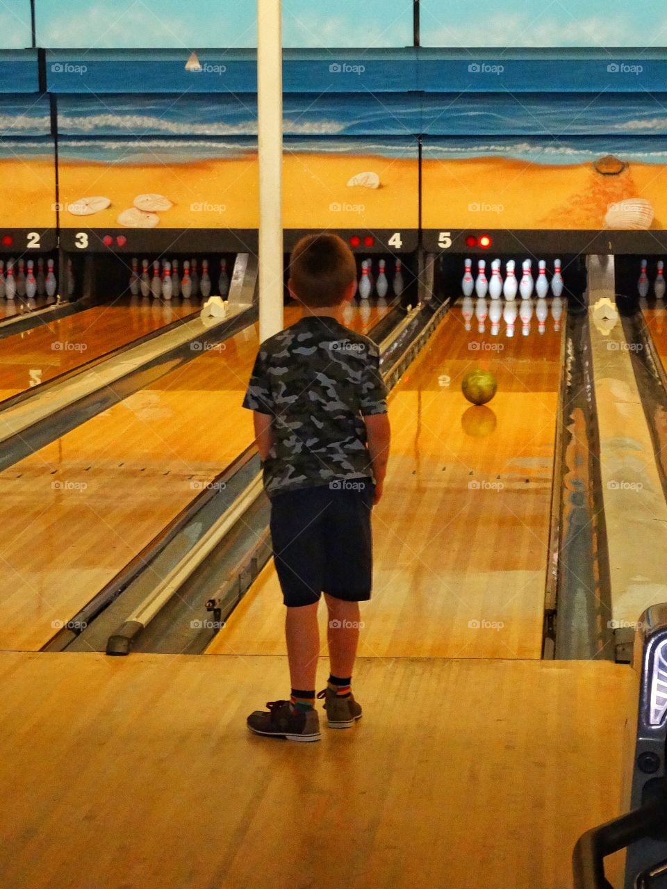 Young Boy Bowling
