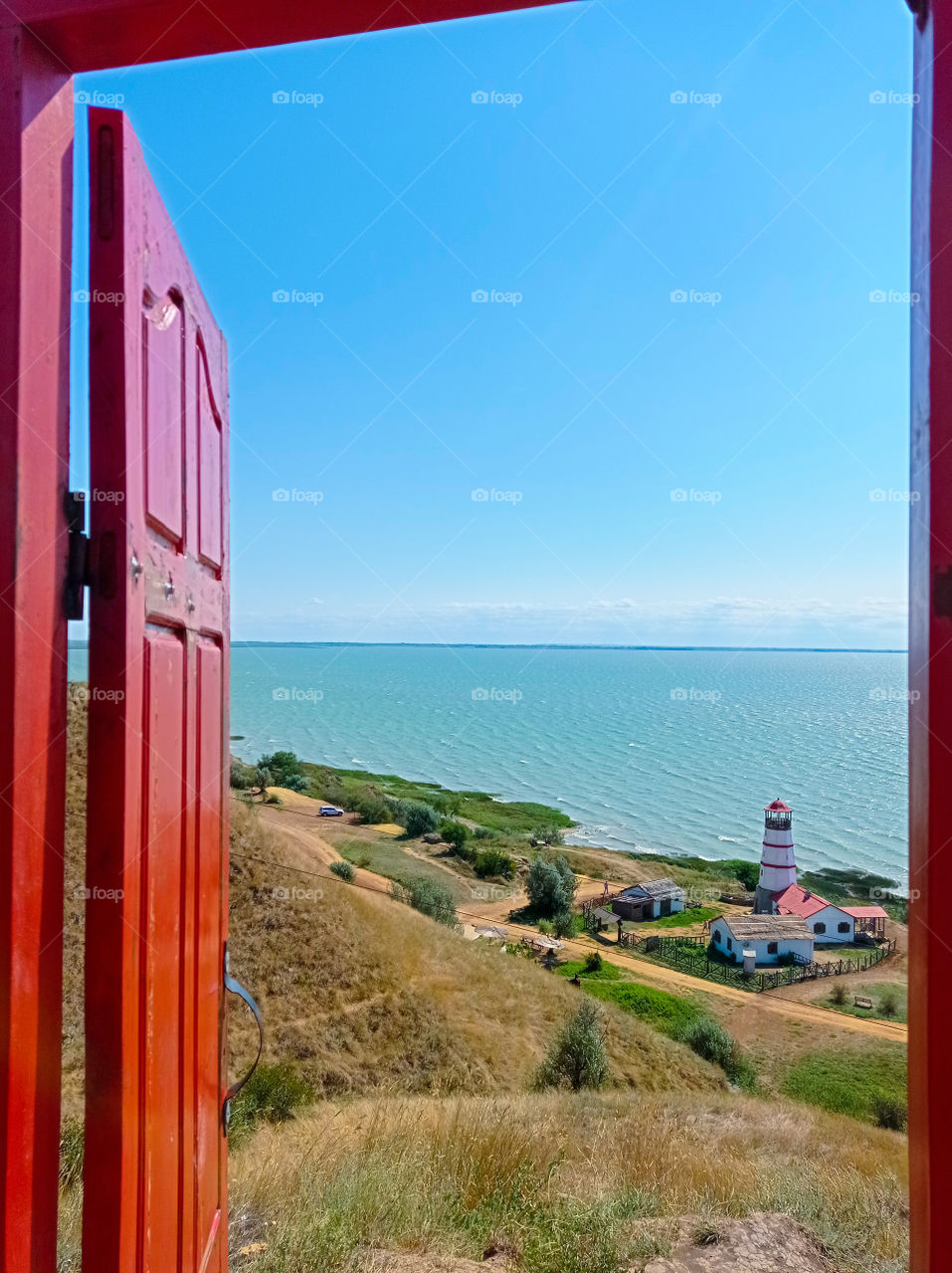 lighthouse by the sea, view from the hill