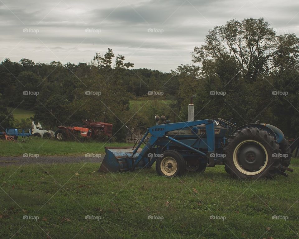 Old tractors surrounded by moody sky