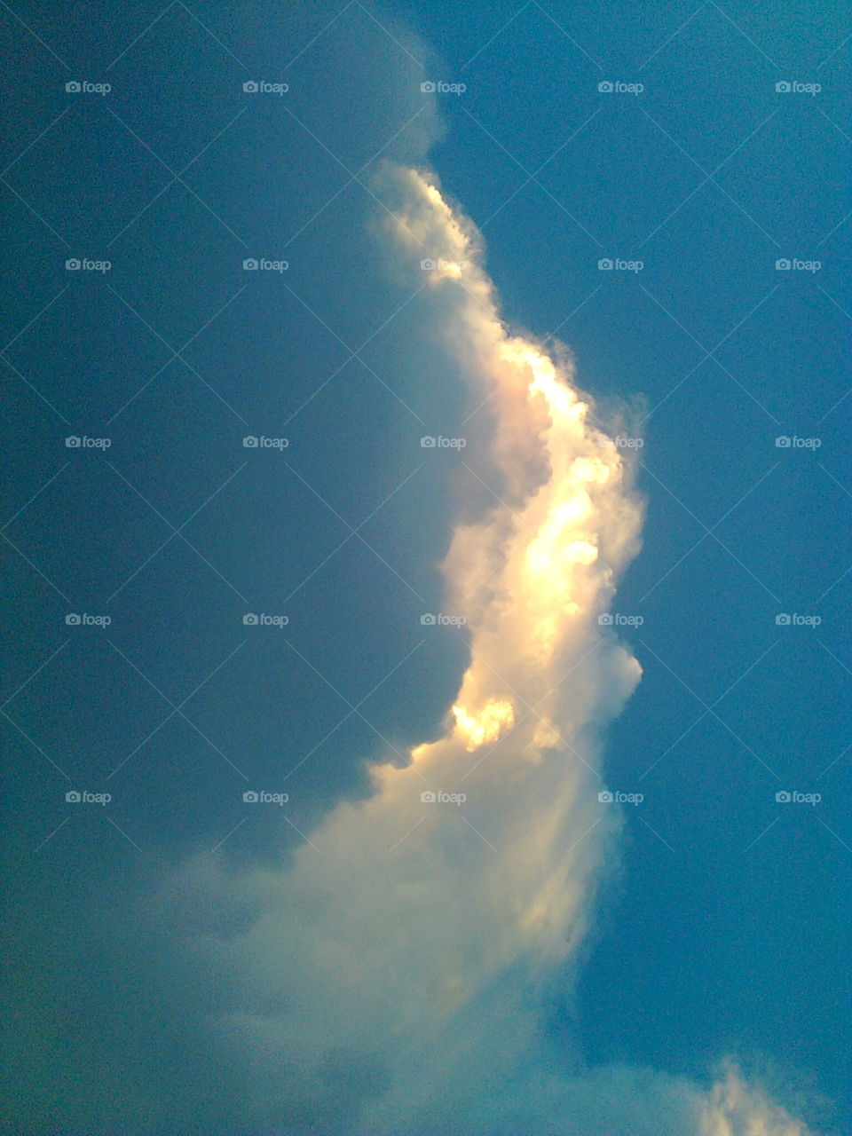 an imaginary angel in sky. its is a view of clouds in summer sky, the clouds form a view of angel