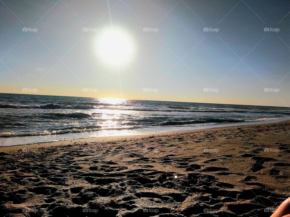Enjoying the beautiful summer sunset sitting on the sandy beach off the Gulf Coast of Florida.