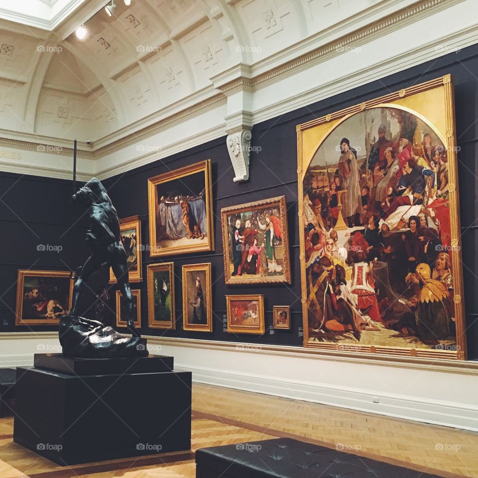 A statue and some artworks in the Art Gallery of New South Wales in Sydney, Australia.