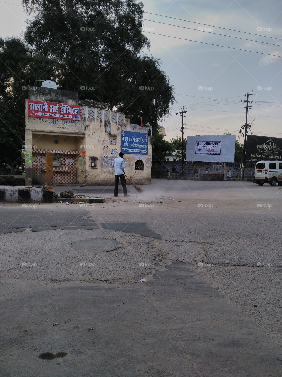 Man cleaning on road