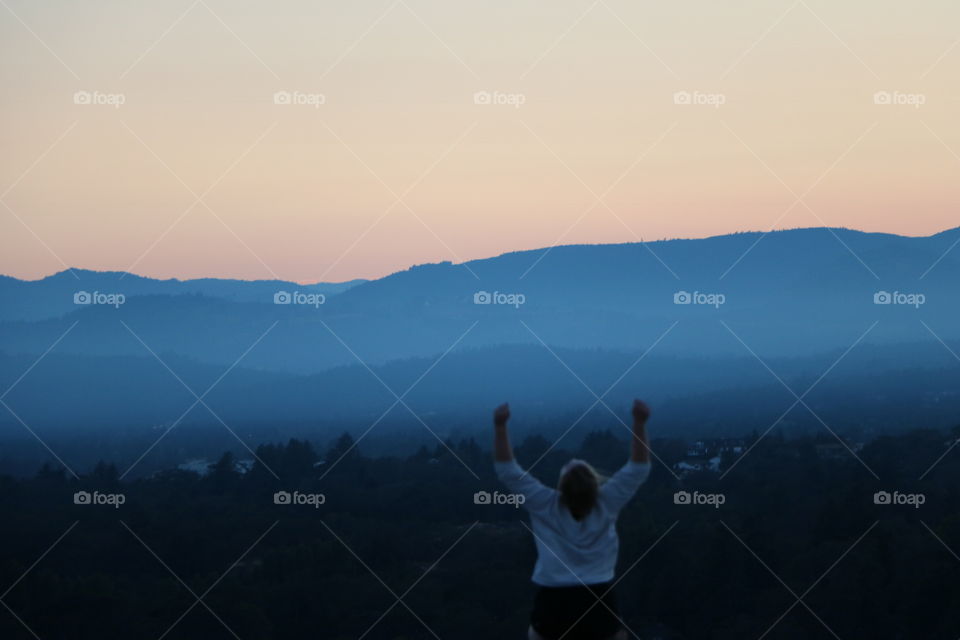 A young woman happy on sunset