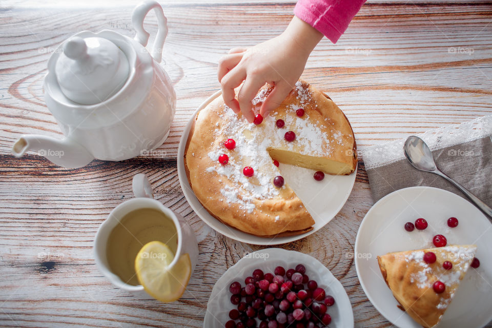 Children breakfast with cheesecake. Hands, detail