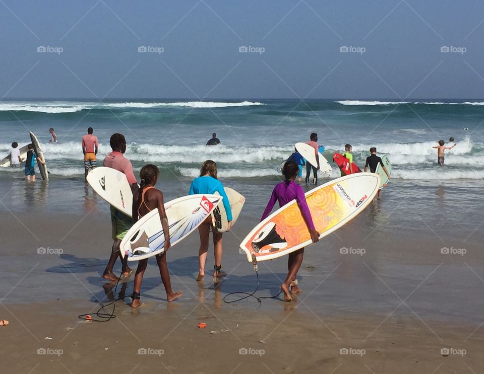 Surf lesson. Kids heading out for a surfing lesson 