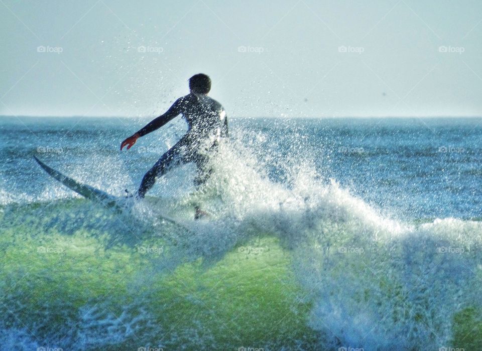 Surfer Riding A Wavecrest