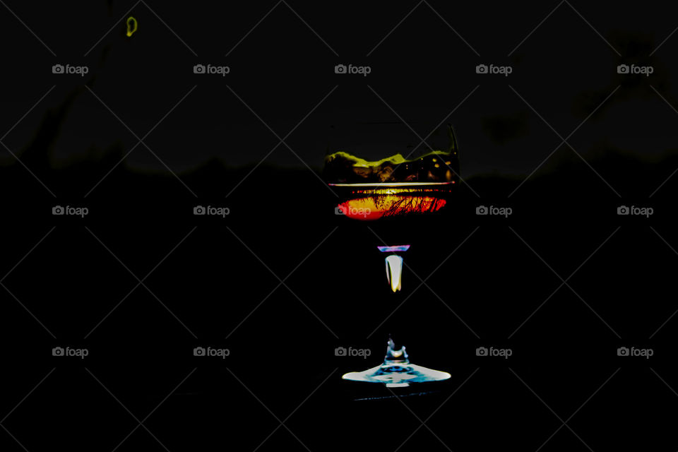 wine glass on the deck with reflection of trees