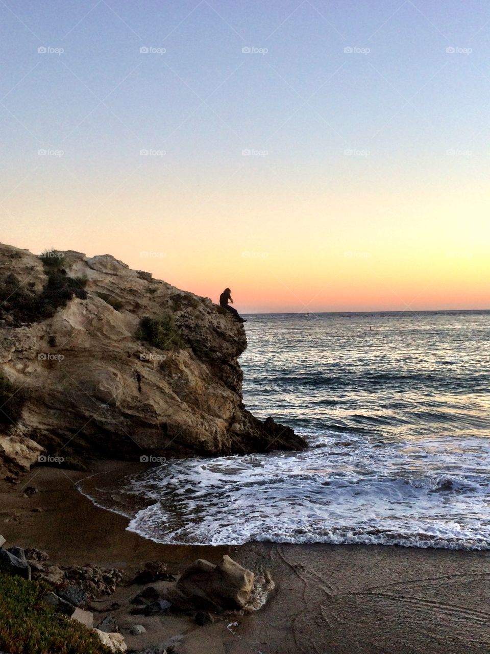 People sitting on rock cliff