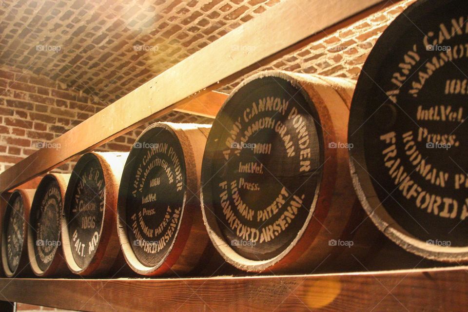 Vintage ammunition barrels lined up in a row in an old fort, Fort Point San Francisco California 