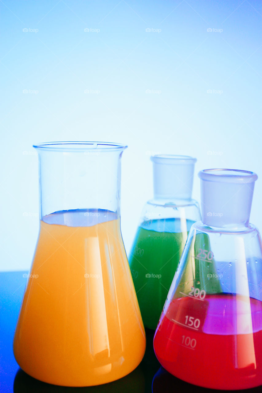 Flasks with colorful fluids, samples in chemical laboratory ready to analyse