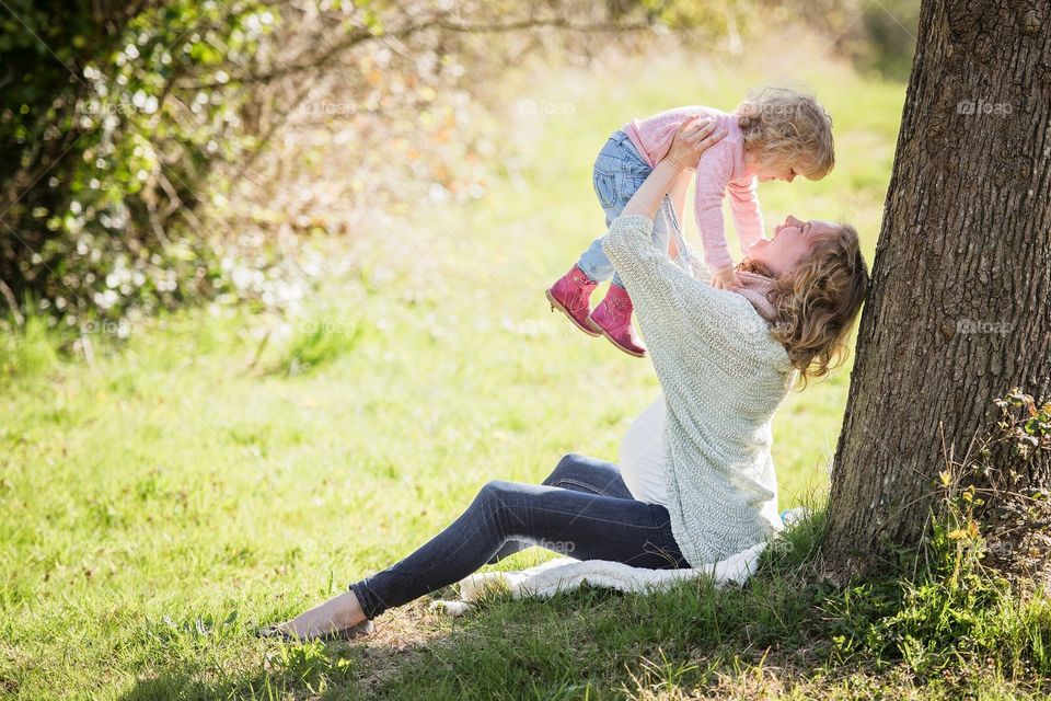mother playing with child in the park