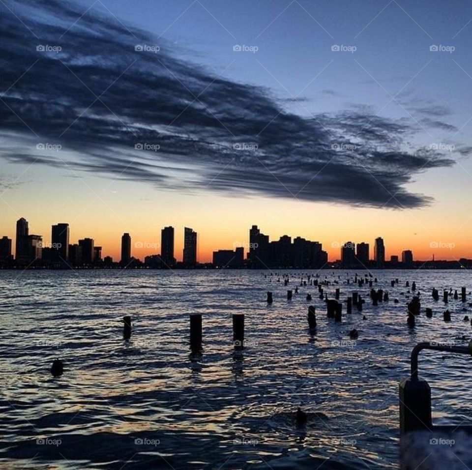 New York sunset . Shot on the west side highway in Nyc over the Hudson River 