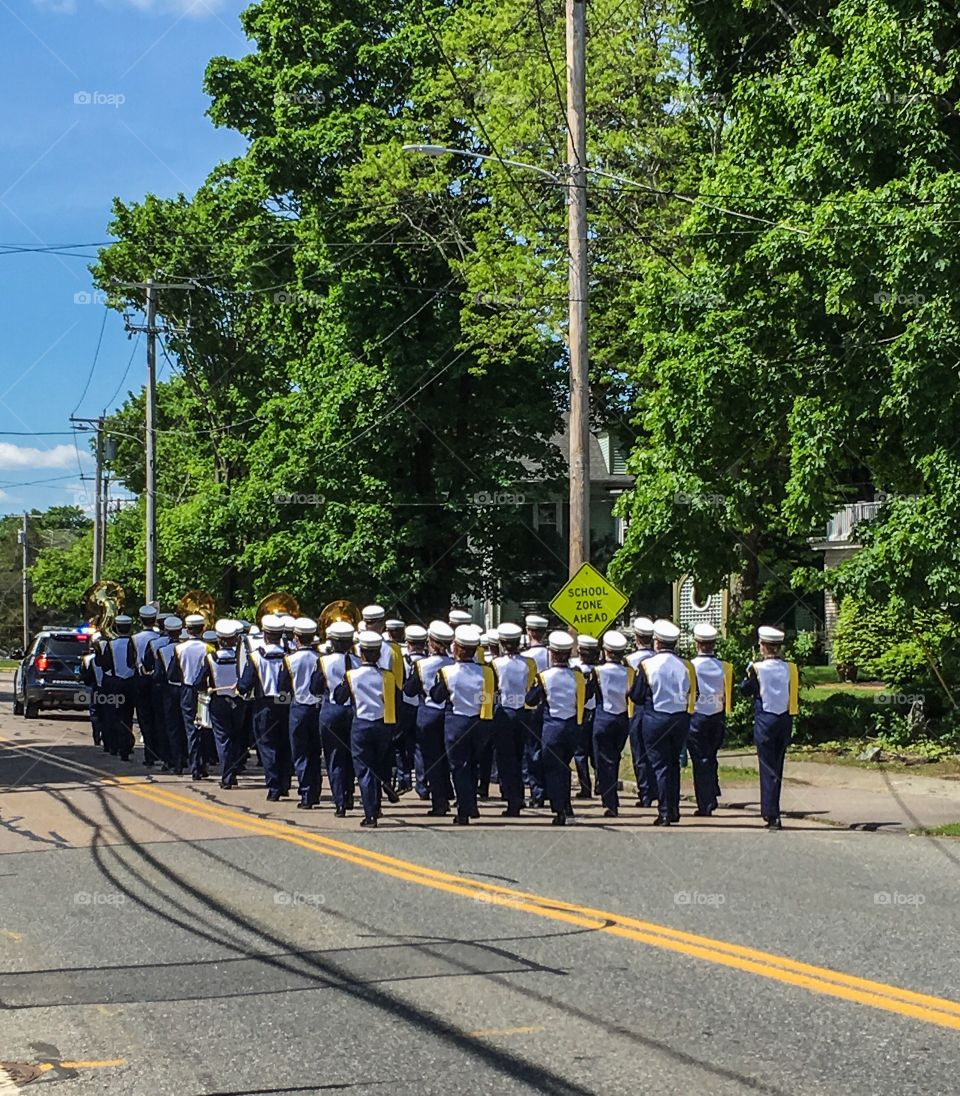 Marching band marching back to the high school after performing at Memorial Day events 