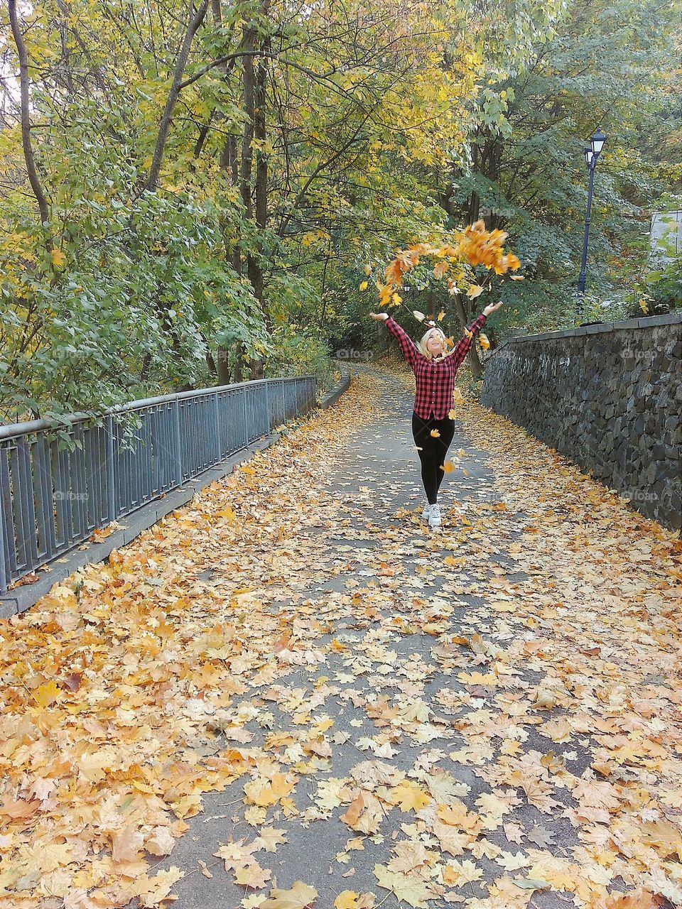 girl throws a bunch of leaves up