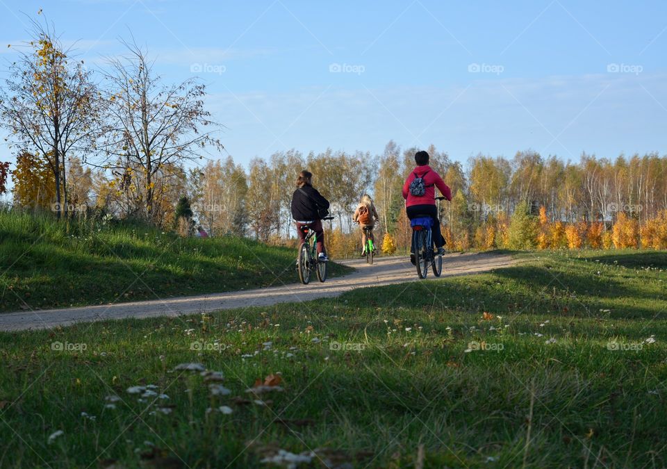 people riding on a bikes autumn beautiful landscape