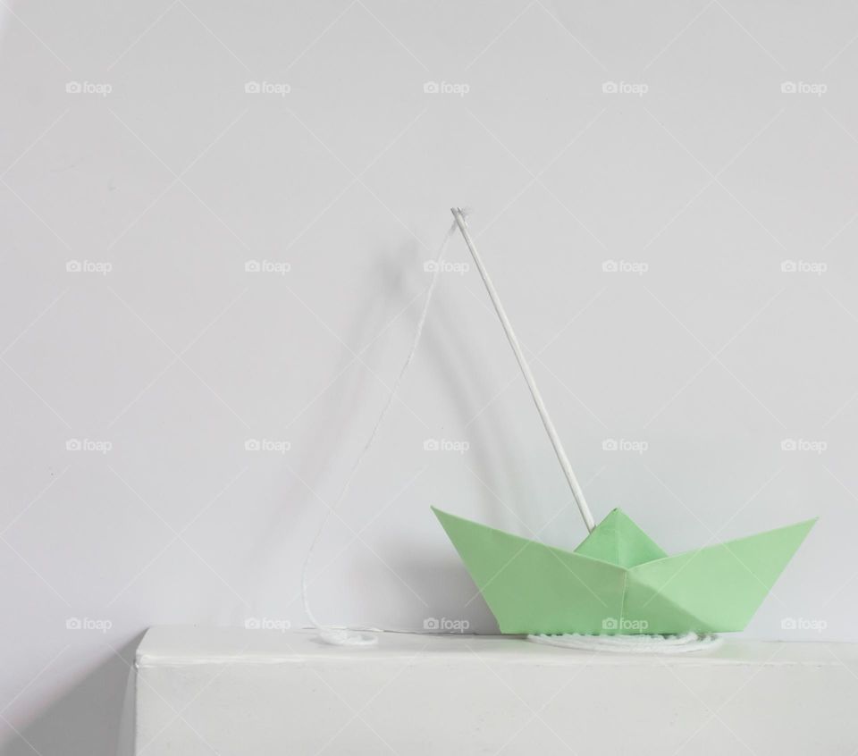 Mint green color paper boat.