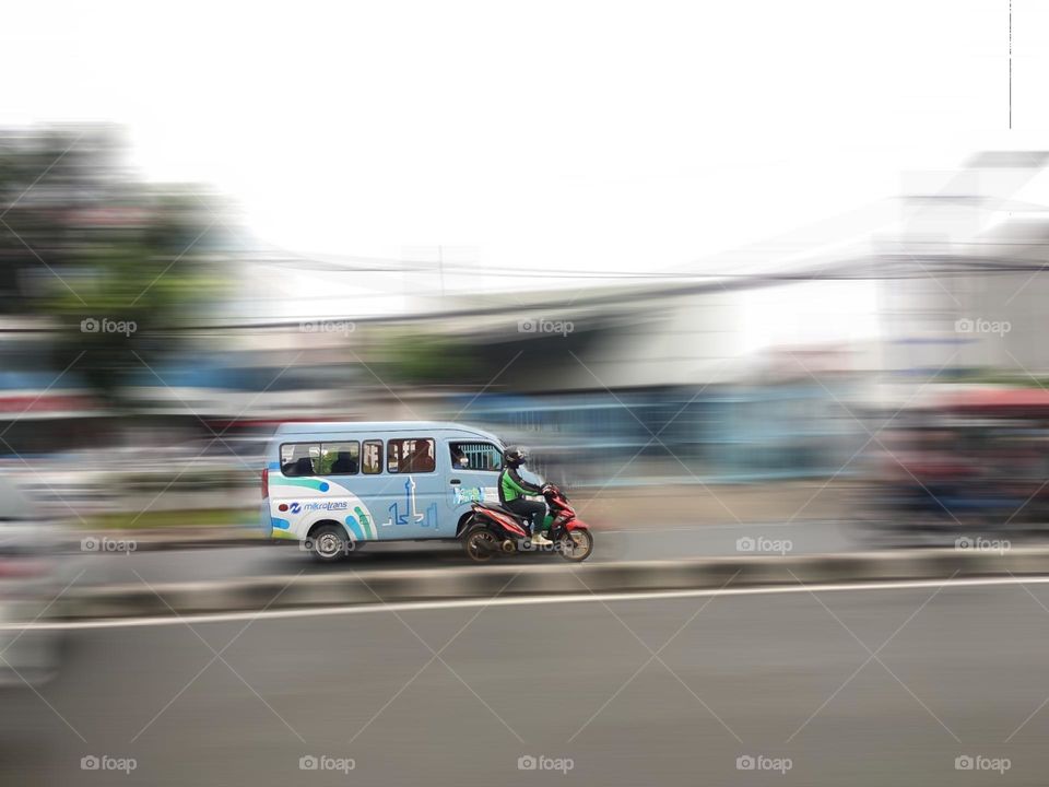 Public transportation and two-wheeled motorbikes go ahead of each other