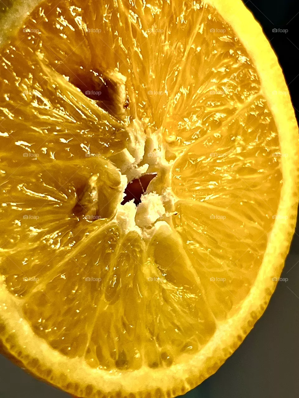 A bright orange cut into pieces. Close-up shot
