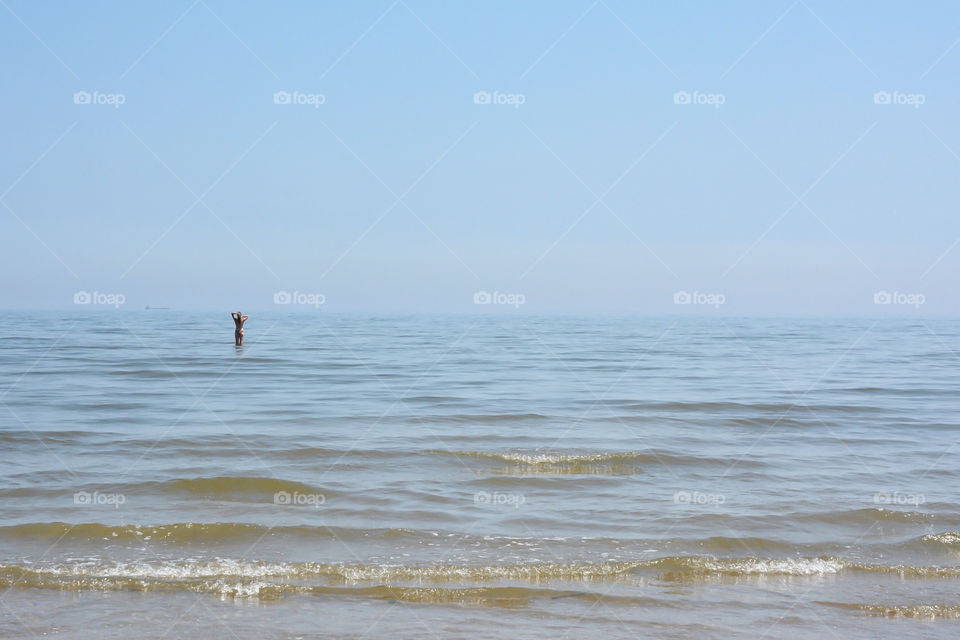 Women in the ocean on a hazy day