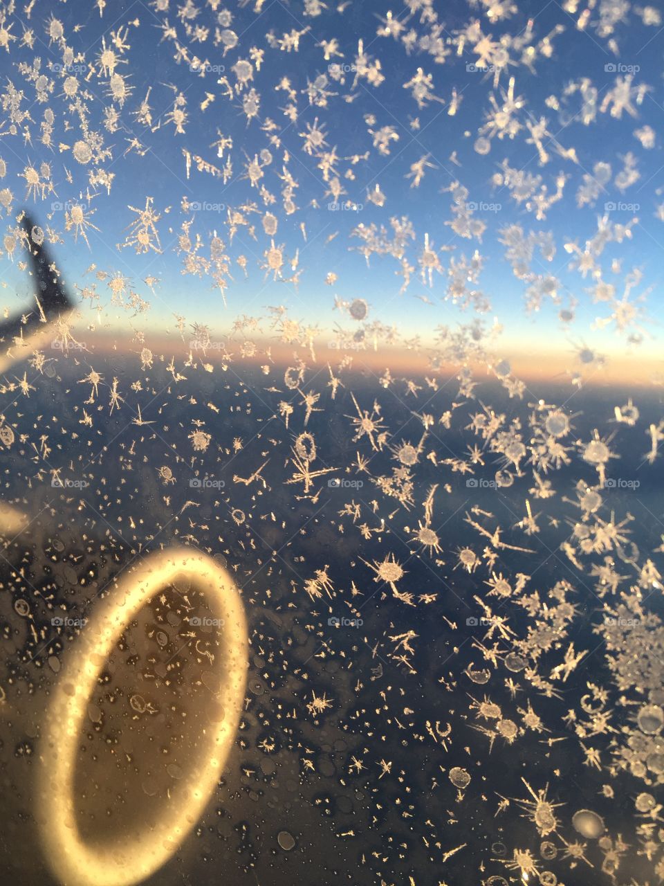 View outside an airplane window at sunset