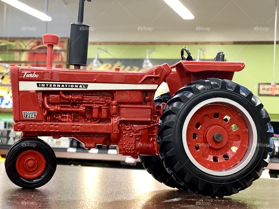Red toy tractor on display