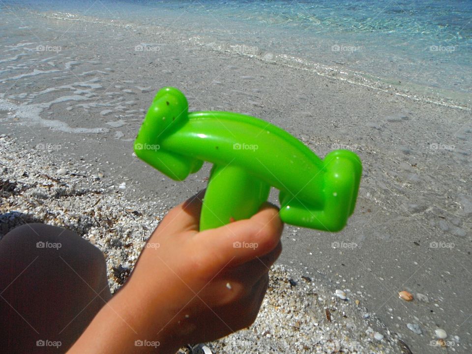 green color story, baby playing with toys in the sand