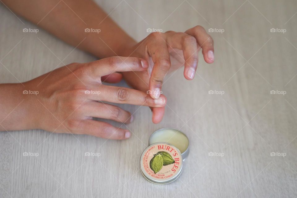 Woman is using Bart's bees cuticle cream