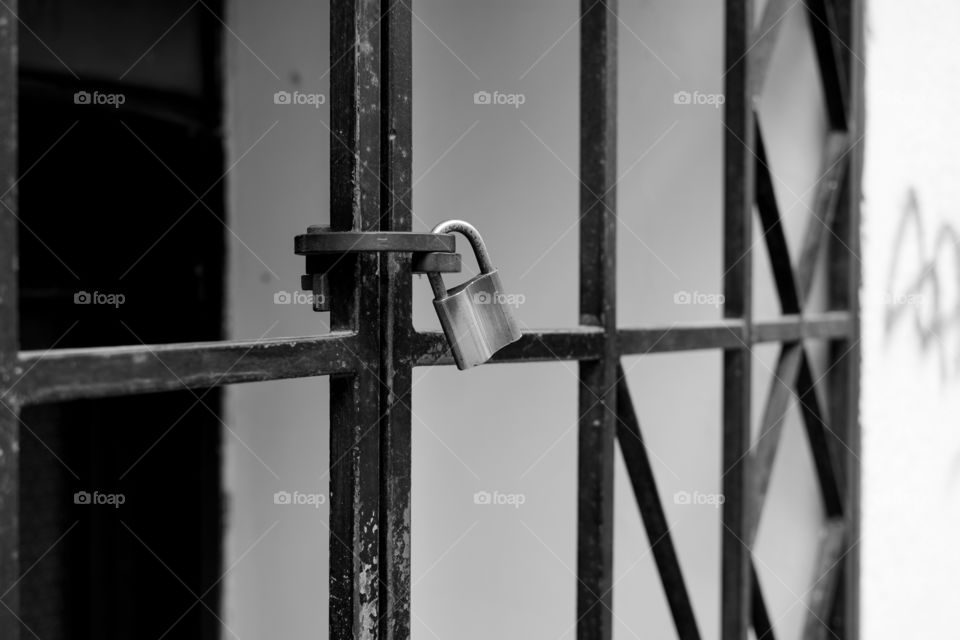 Large padlock on metal gate